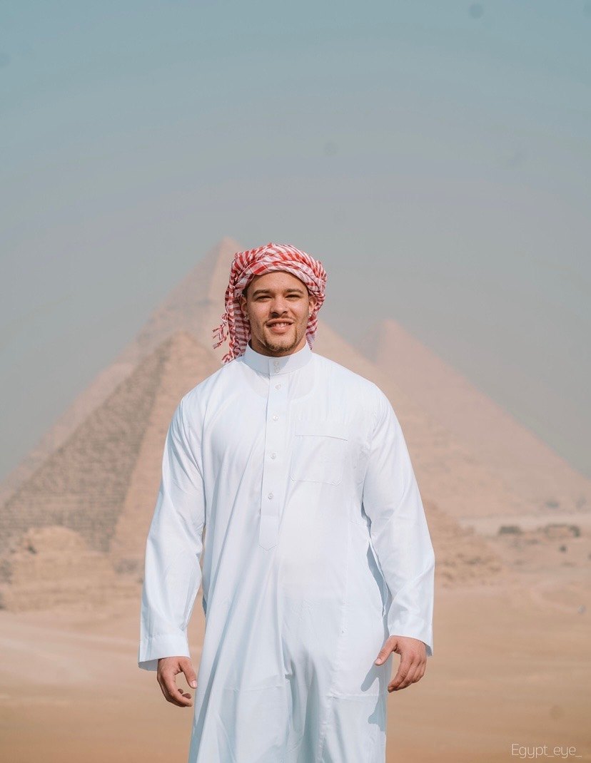 Devin Paladino standing in front of the pyramids at Giza